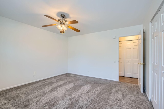 carpeted spare room with ceiling fan