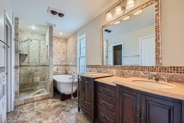 bathroom with vanity, tile walls, and shower with separate bathtub