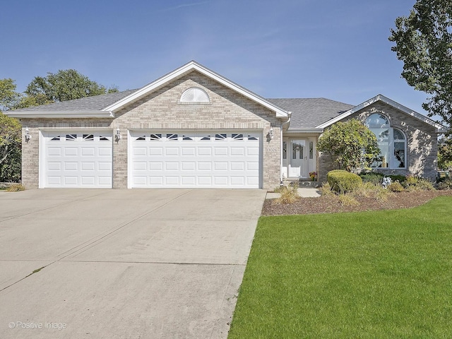 ranch-style house featuring a garage and a front lawn