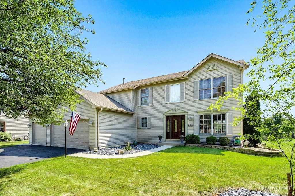 view of front of house with a front lawn and a garage