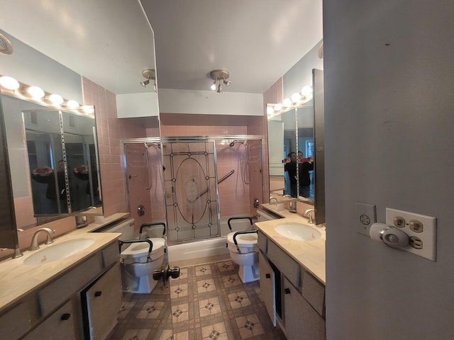 full bathroom with shower / bath combination with glass door, vanity, and toilet