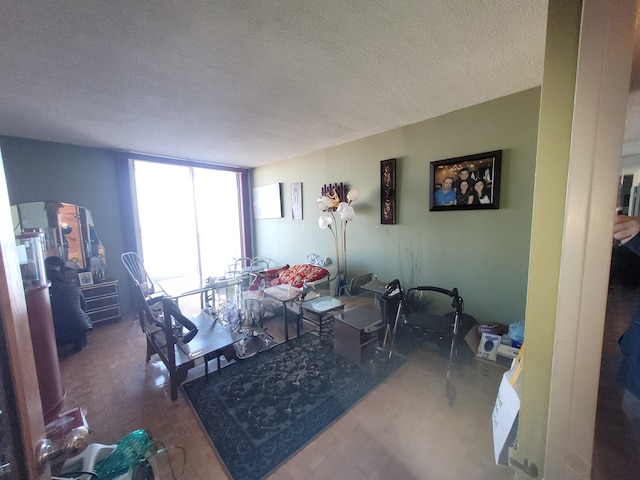 dining space with floor to ceiling windows and a textured ceiling