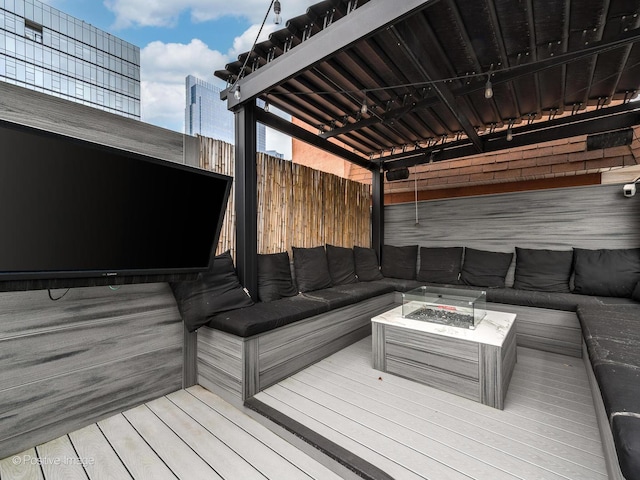 deck featuring an outdoor living space with a fire pit