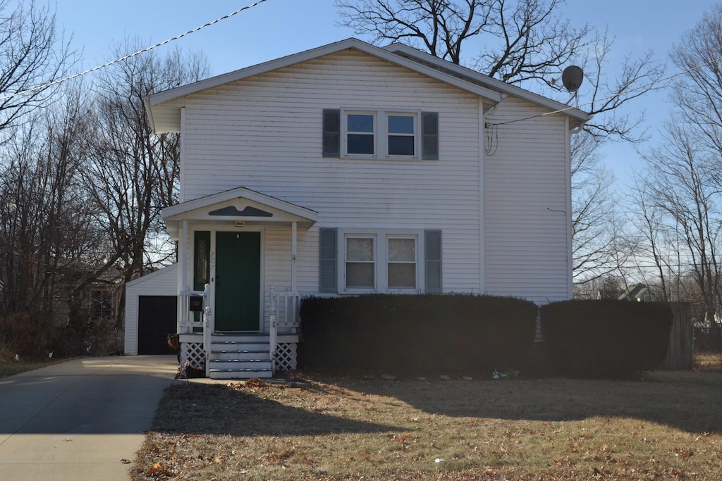 view of front of property featuring a garage and an outbuilding