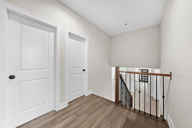 hallway with light hardwood / wood-style floors