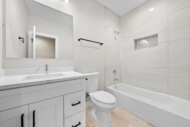 full bathroom featuring toilet, tiled shower / bath, and vanity