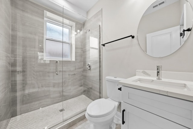 bathroom featuring walk in shower, vanity, and toilet