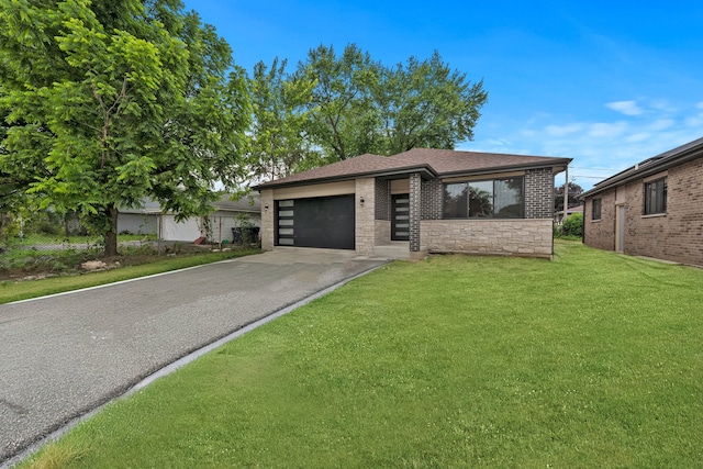 view of front of property featuring a garage and a front lawn