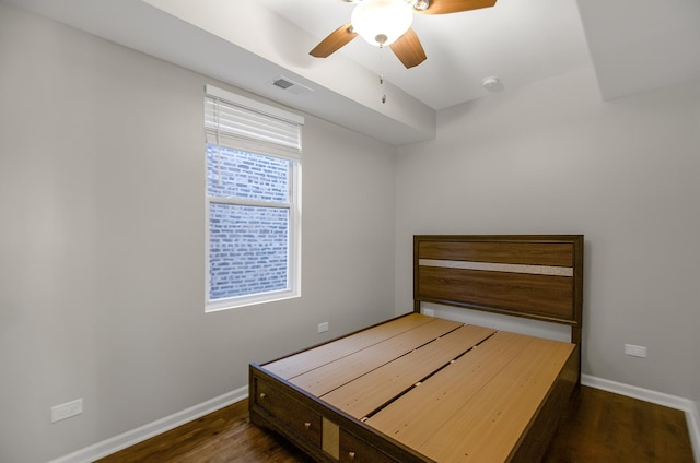 bedroom with ceiling fan and dark hardwood / wood-style floors