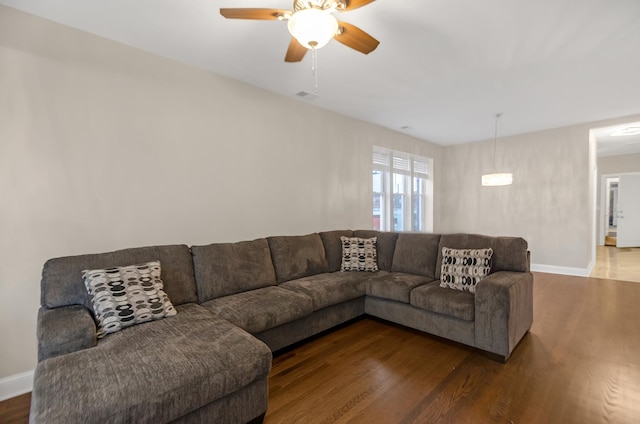 living room featuring ceiling fan and wood-type flooring