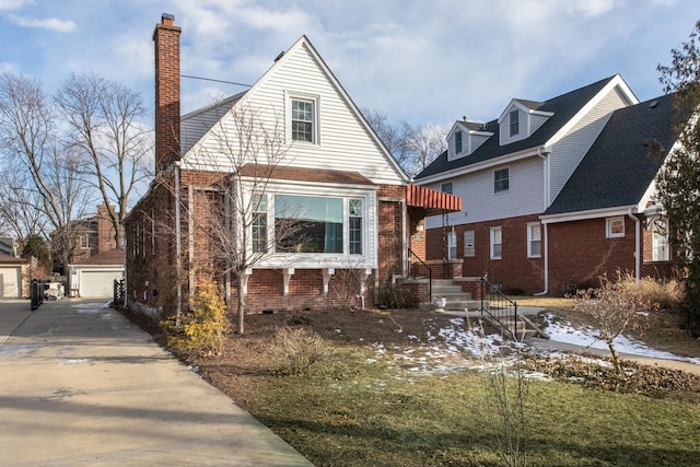 view of front of house with a garage and an outdoor structure