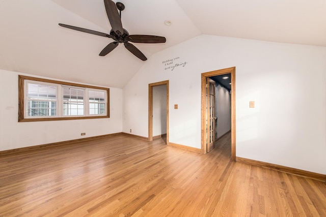 empty room with ceiling fan, lofted ceiling, and light wood-type flooring