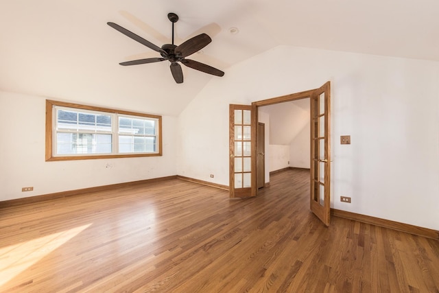 spare room with ceiling fan, hardwood / wood-style floors, french doors, and vaulted ceiling