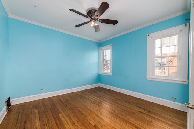 empty room featuring ceiling fan, wood-type flooring, and crown molding