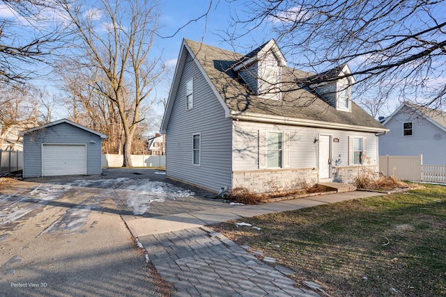 view of front of home featuring a garage and an outdoor structure