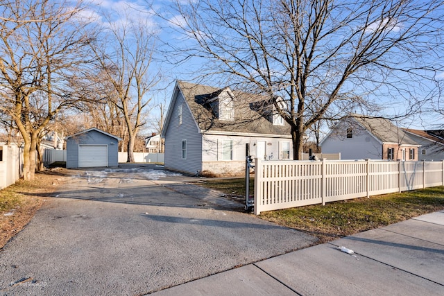 view of property exterior featuring a garage and an outdoor structure