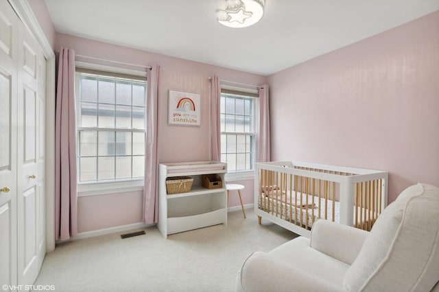 carpeted bedroom with a crib