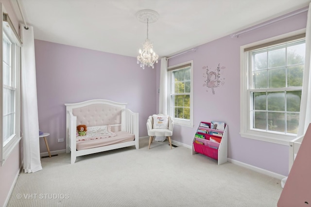 carpeted bedroom with a chandelier