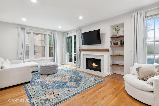 living room featuring hardwood / wood-style flooring and a high end fireplace