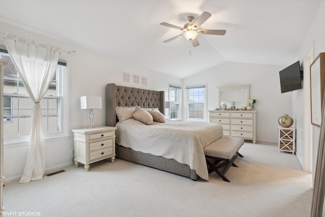 bedroom with light carpet, vaulted ceiling, and ceiling fan