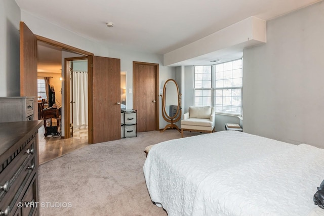 carpeted bedroom with multiple windows