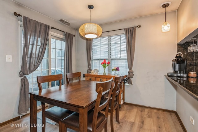 dining area featuring plenty of natural light and light hardwood / wood-style floors