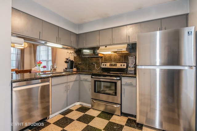 kitchen with gray cabinets, appliances with stainless steel finishes, sink, and decorative backsplash