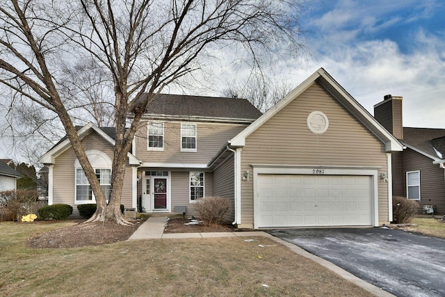 front facade with a garage and a front yard