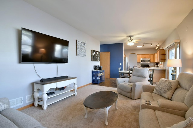 living room with light carpet, track lighting, and ceiling fan