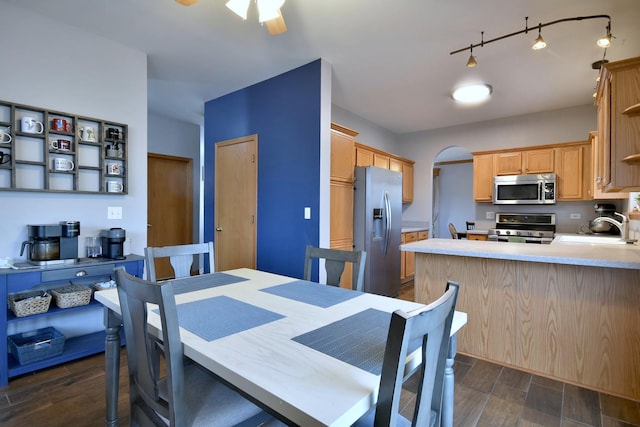 dining room with ceiling fan and sink