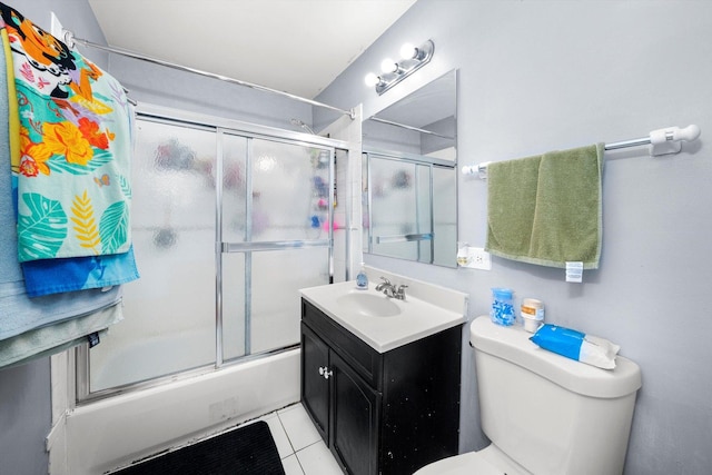 full bathroom featuring shower / bath combination with glass door, vanity, toilet, and tile patterned flooring