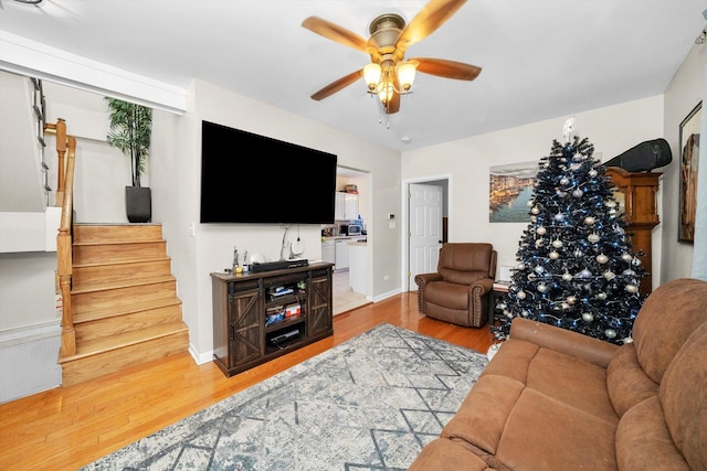 living room with ceiling fan and hardwood / wood-style floors