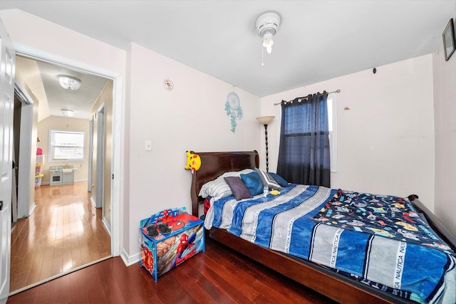 bedroom featuring lofted ceiling and dark hardwood / wood-style floors