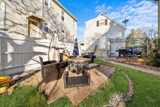 view of patio with an outdoor fire pit and a grill