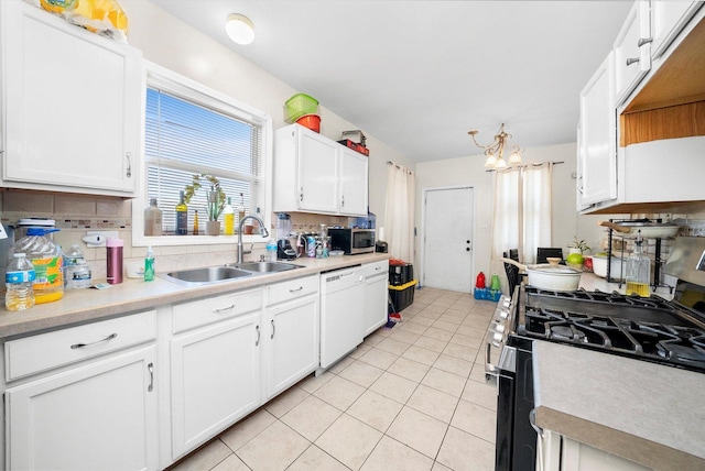 kitchen with light tile patterned floors, white cabinetry, stainless steel appliances, decorative backsplash, and sink