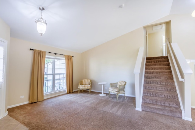 unfurnished room featuring carpet flooring and lofted ceiling