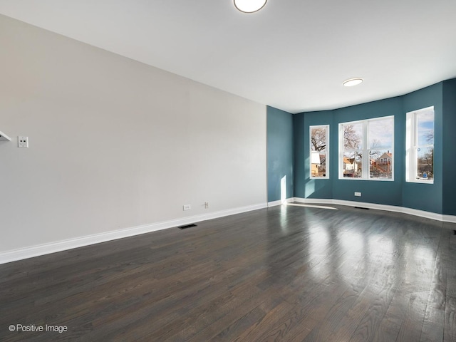 spare room featuring dark hardwood / wood-style floors