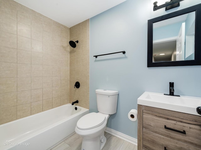 full bathroom featuring hardwood / wood-style floors, toilet, vanity, and tiled shower / bath combo