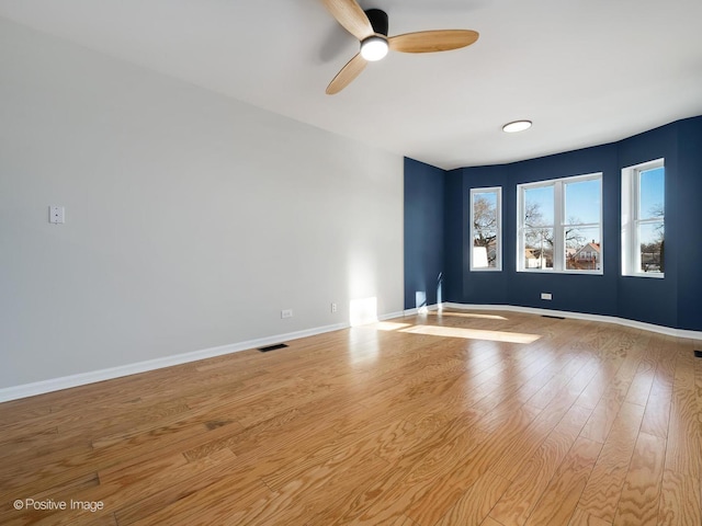 spare room featuring ceiling fan and light wood-type flooring