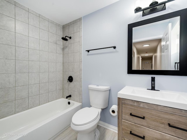 full bathroom with toilet, tiled shower / bath combo, and vanity