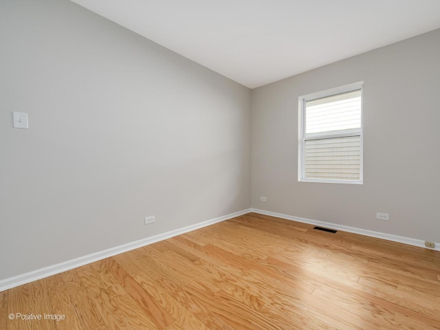 empty room with hardwood / wood-style floors