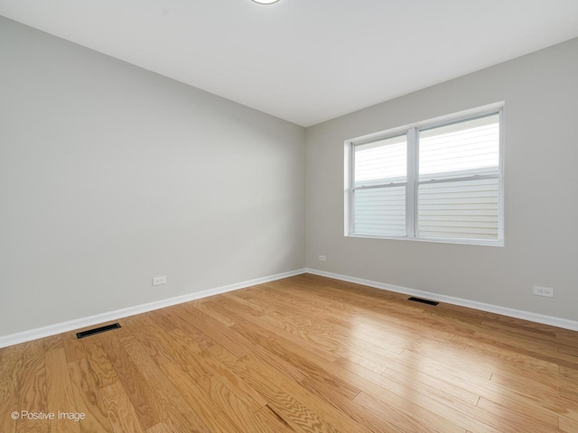 empty room with light hardwood / wood-style flooring