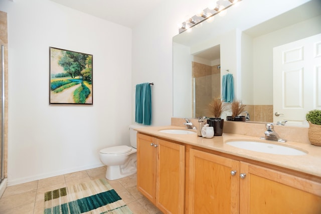 bathroom with toilet, walk in shower, vanity, and tile patterned flooring