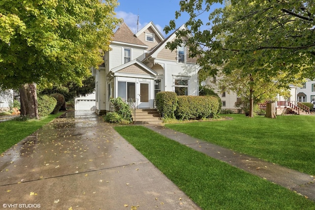 view of front of property with a garage and a front yard