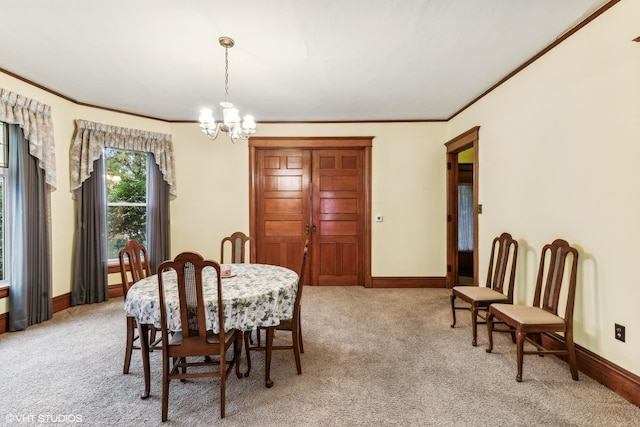 dining room with a chandelier, light colored carpet, and ornamental molding