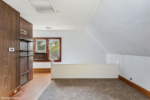 additional living space featuring light carpet and lofted ceiling