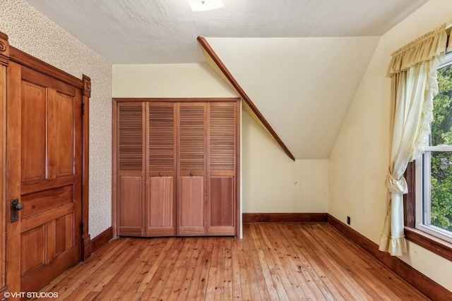 bonus room featuring vaulted ceiling and light hardwood / wood-style floors