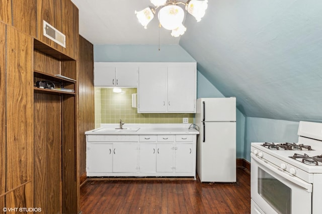 kitchen with lofted ceiling, dark hardwood / wood-style floors, sink, white appliances, and white cabinets