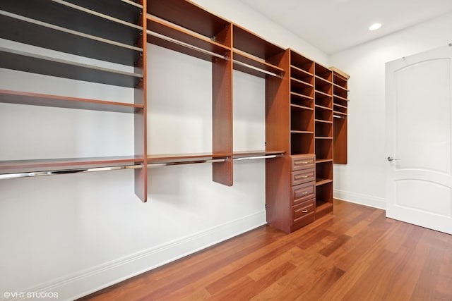 walk in closet featuring wood finished floors