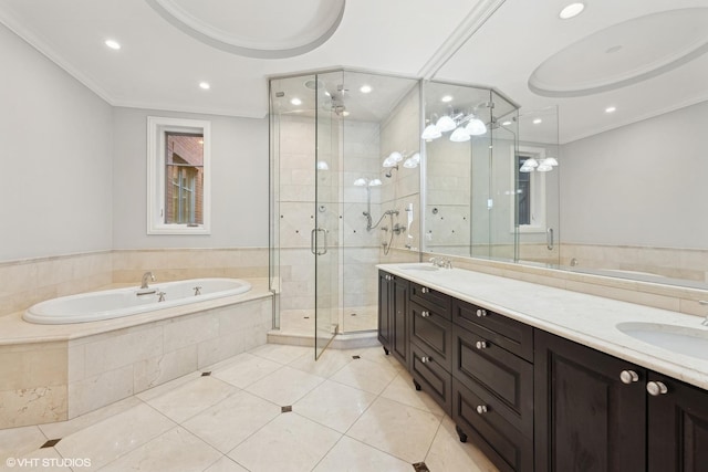 bathroom with double vanity, ornamental molding, a sink, and a bath